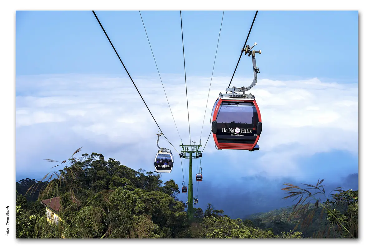 Cable car cabins on their cables above a layer of clouds