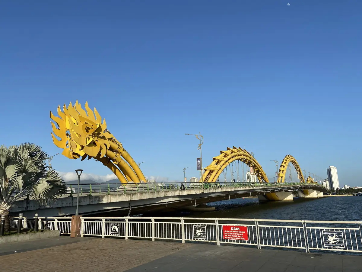 Golden dragon body arching over the bridge in daylight