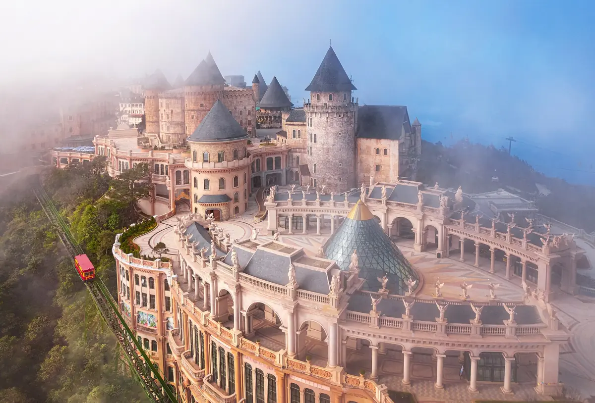 Aerial view of the castle-style village buildings in light fog