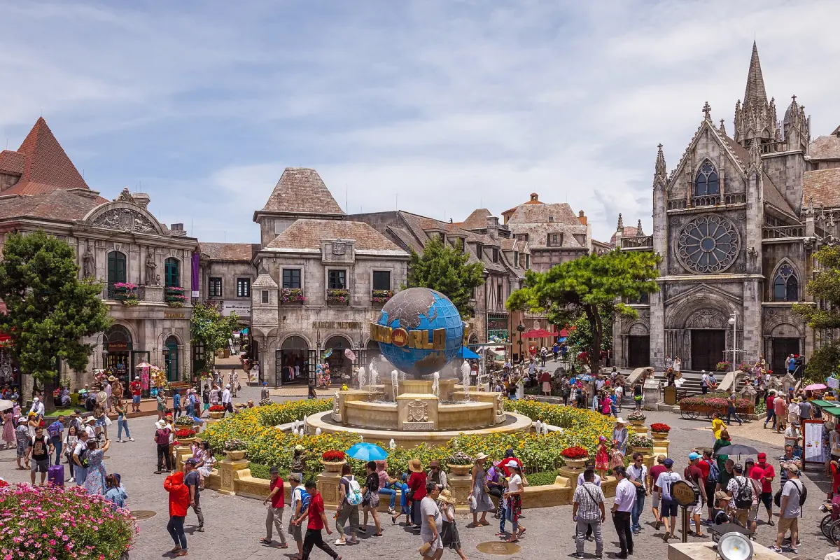 Village square with fountain and a neo-gothic church facade