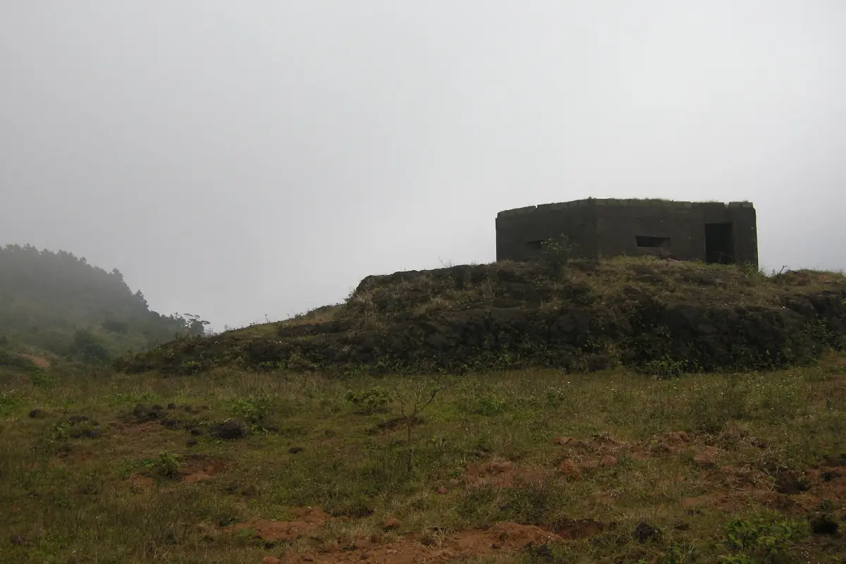 Old stone fortification on a grassy hilltop of the pass