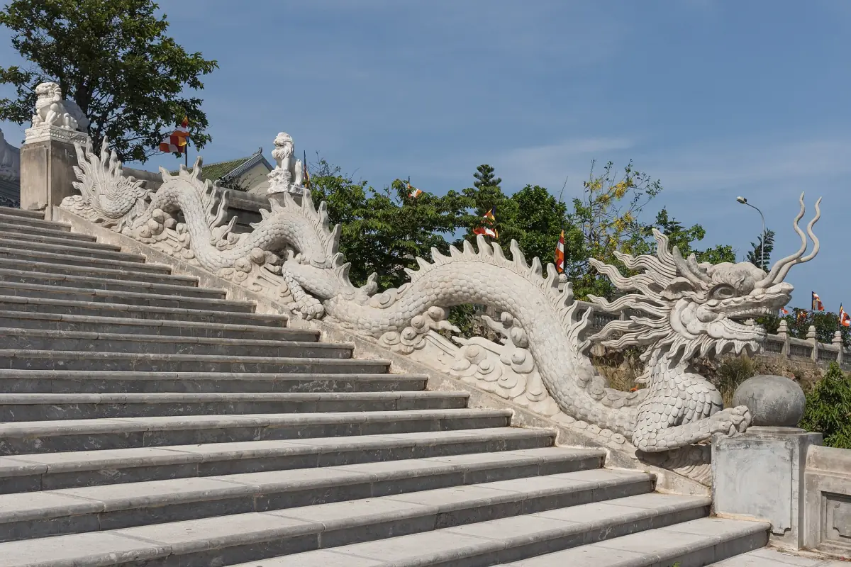Stone steps with a carved dragon balustrade leading to a pagoda